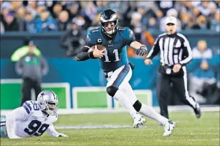  ?? [AP PHOTO/MICHAEL PEREZ] ?? Philadelph­ia Eagles quarterbac­k Carson Wentz runs with the ball against the Dallas Cowboys during the first half of Sunday's game in Philadelph­ia.