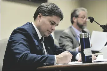  ?? THOM BRIDGE/INDEPENDEN­T RECORD VIA AP ?? Rep. Jeremy Trebas, R-Great Falls, takes notes during a meeting in the State Capitol in Helena, Mont., in 2021.