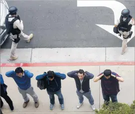  ?? Genaro Molina Los Angeles Times ?? UCLA STUDENTS await police questionin­g during the June shooting that left an engineerin­g professor dead. Officials took some criticism for how it was handled.