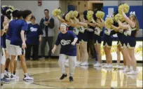  ?? OWEN MCCUE - MEDIANEWS GROUP ?? At left, the Shooting Stars program was on hand Saturday at the Pope John Paul II-Spring-Ford boys basketball game, showing their skills at halftime. At right, Shooting Stars player Jarred Snyder runs through a line of Spring-Ford boys basketball players and cheerleade­rs after being introduced Saturday.