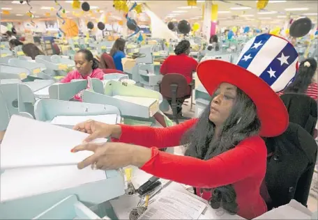  ?? Rich Pedroncell­i Associated Press ?? BRENDA GIPSON sorts California income tax returns at the Franchise Tax Board office in Sacramento on Tuesday, the filing deadline.