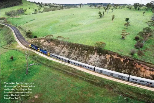  ??  ?? The Indian Pacific begins its climb out of the Tarana Valley on the way to Lithgow. Two locomotive­s are needed to power the train over the
Blue Mountains.