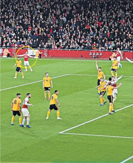  ??  ?? Relief: Henrikh Mkhitaryan (circled) scores with an 86th-minute cross