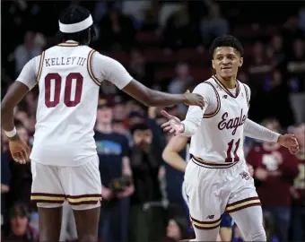  ?? MATT STONE — BOSTON HERALD ?? Boston College’s Chas Kelley, left, and Makai Ashton-Langford celebrate during the Eagles’ 63-48 upset win over No. 6 Virginia at the Conte Forum.