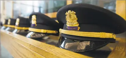  ?? Hearst Connecticu­t Media ?? Caps before the police promotion ceremony inside Government Center in downtown Stamford in September. Police dominate the annual list of the city’s top earners.