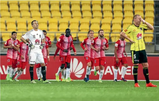  ?? PHOTOS: GETTY IMAGES ?? In front of empty seats, Wellington Phoenix goalkeeper Glen Moss, left, and defender Ryan Lowry show their disappoint­ment after one of five Melbourne City goal on Saturday.