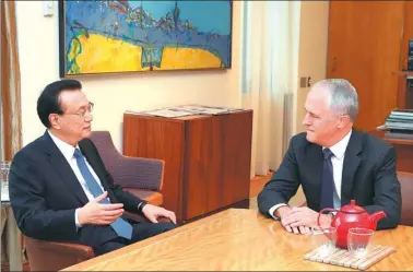  ?? PANG XINGLEI / XINHUA ?? Premier Li Keqiang meets with Australian Prime Minister Malcolm Turnbull at Parliament House in Canberra, Australia, on Thursday. Li said China will work with Australia to further boost bilateral trade.