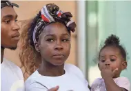  ?? CARLY BOWLING/THE REPUBLIC ?? Dravon Ames, Iesha Harper and their daughter appear Tuesday outside Phoenix City Hall.