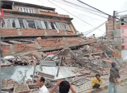  ??  ?? A demolished building in Nepal after the April earthquake.