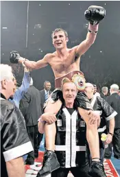  ??  ?? Enzo Calzaghe hoists his son Joe aloft after the victory over Jeff Lacy in Manchester in 2006 that gave Joe the world super-middleweig­ht title