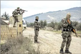  ?? AP/DHA-DEPO ?? Turkey-backed Free Syrian Army fighters secure an area as the Turkish army’s border operation continues Wednesday in Azaz in northweste­rn Syria.