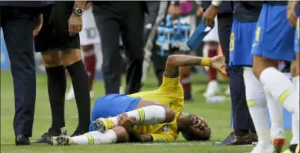  ?? THE ASSOCIATED PRESS ?? Brazil’s Neymar lies on the ground, faking an injury during his team’s win over Mexico in the round of 16.