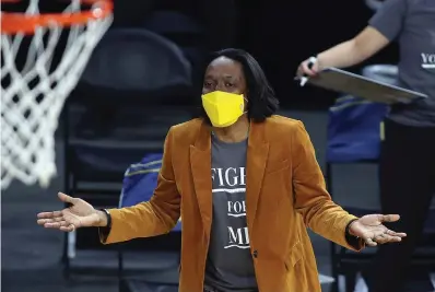  ?? The Associated Press ?? California head coach Charmin Smith talks with an official during a game in the first round of the Pac-12 women’s tournament on March 3, 2021, in Las Vegas. Smith and her players figured they had gone through the worst of the pandemic in 2020-21.