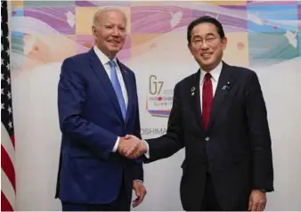  ?? ?? Japanese Prime Minister Fumio Kishida (right) and US President Joe Biden shake hands ahead of their talks in Hiroshima yesterday, on the eve of the three-day Group of Seven summit in the western Japanese city.
Photo