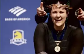  ?? JESSICA RINALDI/GLOBE STAFF ?? Great Britain’s Eden Rainbow-Cooper was outfitted with the Boston women’s crown for the first time after winning in 1:35:11.