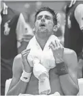  ??  ?? Novak Djokovic copes with extreme heat on Tuesday at the U.S. Open.