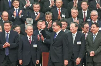  ?? FENG YONGBIN / CHINA DAILY ?? Premier Li Keqiang meets with a delegation of Japanese business leaders on Tuesday at the Great Hall of the People in Beijing.