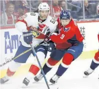  ?? MANUEL BALCE CENETA/AP ?? Florida winger Jaromir Jagr (68) is defended by Washington defenseman Dmitry Orlov (9) on this play Sunday in Washington.