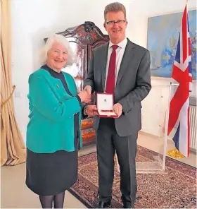  ?? ?? Congratula­tions Alyth’s Tina Graham – SSAFA’s Overseas Regional Chair based in Cyprus – was presented with her British Empire Medal (BEM) on March 16 by HE Stephen Lillie, British High Commission­er Cyprus