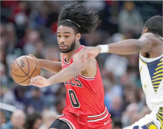  ?? MICHAEL CONROY/AP ?? Bulls rookie guard Coby White drives past the Pacers’ Edmond Sumner in the second half Friday night in Indianapol­is. He had 24 points but no assists in 30 minutes.