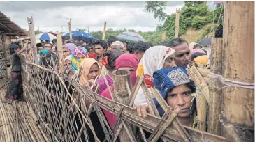  ?? AFP ?? Rohingya refugees queue at an aid relief distributi­on centre at Balukhali refugee camp near Cox’s Bazar.