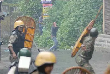  ?? — AFP ?? A supporter of the GJM fires a slingshot during clashes with security forces in Darjeeling on Saturday.