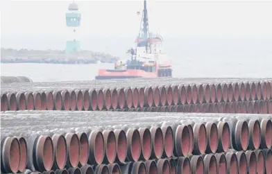  ?? STEFAN SAUER/DPA ?? Pipes for the Nord Stream 2 Baltic Sea gas pipeline are stored at the port of Mukran near Sassnitz, Germany, in 2020. Russia’s natural gas pipeline to Europe is built and ready to flow. But not so fast. The Nord Stream 2 pipeline faces a rocky road ahead.
