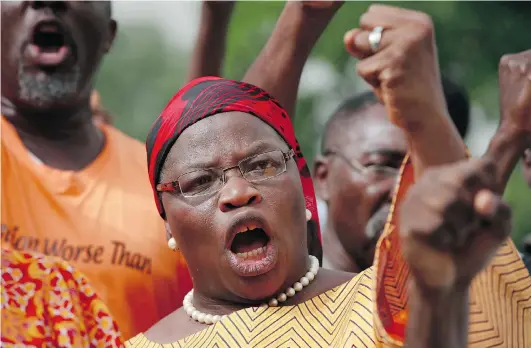  ?? SUN DAY ALAMBA/ THE ASSOCIATED PRESS ?? A woman shouts dur ing a ral ly in Abu ja, Ni geria on Sun day, call ing on the gov ern ment to res cue the school girls kid nap ped from the Chibok sec ond ary school.