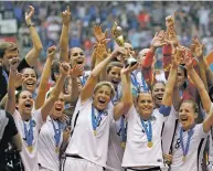  ?? ASSOCIATED PRESS FILE PHOTO ?? The U.S. Women’s National Team celebrates with the trophy after beating Japan 5-2 in the 2015 FIFA Women’s World Cup championsh­ip in Vancouver. The U.S. Soccer Federation and the World Cup champion women’s team have agreed on a labor contract, settling...