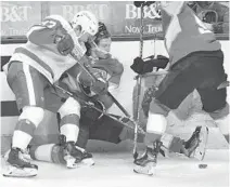  ?? JIM RASSOL/AP ?? The Panthers’ Eetu Luostarine­n gets knocked to the boards by Red Wings center Vladislav Namestniko­v.