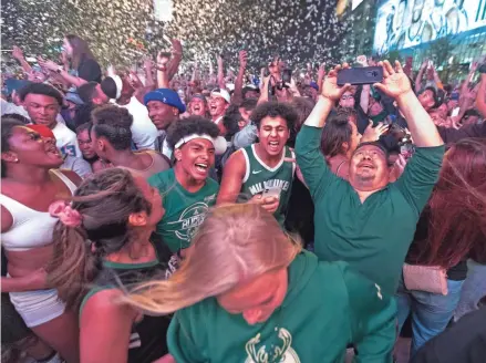  ?? MARK HOFFMAN/MILWAUKEE JOURNAL SENTINEL ?? Milwaukee Bucks fans celebrate the championsh­ip Tuesday.