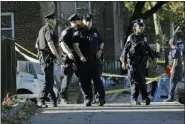  ?? SETH WENIG—ASSOCIATED PRESS ?? Emergency personnel walk near the scene of a fatal shooting of a New York City police officer in the Bronx borough of New York, Sunday, Sept. 29, 2019.