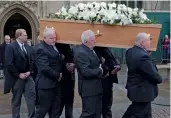  ?? — AFP ?? Porters of Gonville & Caius College, act as pallbearer­s and carry the coffin of scientist Stephen Hawking after the funeral service in Cambridge on Saturday.