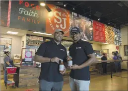  ?? JORDYN COURTNEY — SMOKEY JOHN’S VIA AP ?? Juan Reeves, VP of Smokey John’s BBQ, left, and his brother Brent Reeves, President of Smokey’s John’s BBQ, hold bottles of their famous barbecue sauce, which is available by mail order, at Smokey John’s BBQ in Dallas on Dec. 10.