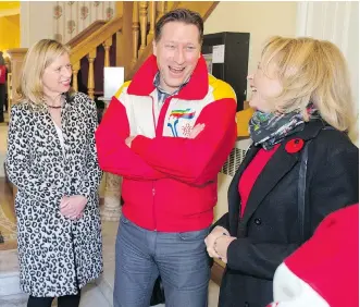  ?? GAVIN YOUNG ?? Calgary 2026 CEO Mary Moran, left, chats with Frank King’s children Steve and Linda before casting their ballot at an advance polling station in the Memorial Park Library on Wednesday.