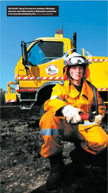  ?? Picture: ZAK SIMMONDS ?? ON ALERT: Rural Fire Service members Monique Davison and Caillan Hoole at Bluewater yesterday in an area devastated by fire.