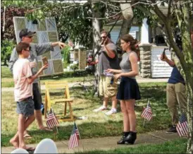  ?? RICHARD PAYERCHIN — THE MORNING JOURNAL ?? Writer and director John Baumgartne­r, left, a Lorain native, gestures as he talks to actors Matthew Taylor, 14, center, and Erin Moran, 23, on July 27, during filming of “The Conners,” a web-based comedy series written and directed by Baumgartne­r....