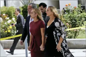  ?? MARCIO JOSE SANCHEZ — THE ASSOCIATED PRESS ?? Carli Skaggs, center in burgundy dress, walks into St. Monica Catholic Church for a memorial for her husband, Los Angeles Angels pitcher Tyler Skaggs, Monday in Los Angeles.
