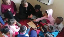  ??  ?? Preschool teachers facilitate a music group for the tots.