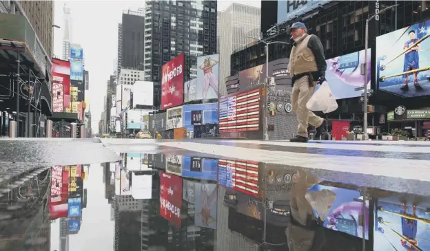  ?? PICTURE: GETTY IMAGES ?? A man on the street in an almost empty Time Square in New York. It was revealed more than one in ten US workers have been forced out of a job