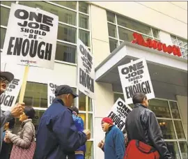  ?? Ben Margot Associated Press ?? STRIKING workers picket at a Marriott in San Francisco in October. In Southern California, the union is seeking higher wages and better healthcare benefits.