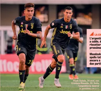  ?? AFP/GETTY ?? Paulo Dybala, 24 anni, con Cristiano Ronaldo, 33. Sotto l’argentino (a destra) in panchina