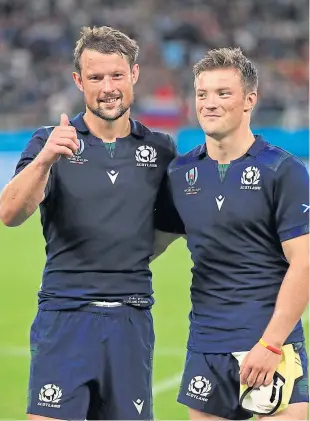  ?? Pictures: PA. ?? Clockwise from above left: Peter and George Horne celebrate after the hammering of Russia; George after scoring Scotland’s third try; some Japanese schoolchil­dren showing their support for the team.