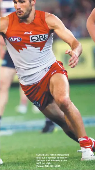  ??  ?? SUPERSTAR: Patrick Dangerfiel­d fires out a handball in front of Sydney’s Josh Kennedy at the MCG last night. Picture. PHIL HILLYARD