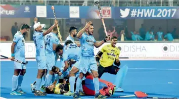  ??  ?? Indian players celebrate their win over Belgium in the quarter- final of the Men’s Hockey World League Final at the Kalinga Stadium in Bhubaneswa­r on Wednesday. The hosts won 3- 2 in a penalty shoot- out. —