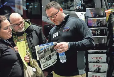  ?? ?? Shawn Coon of RCD RV helps potential buyers view different floor plans. The 2022 show has nearly 250,000 square feet of recreation­al vehicles and boats on display.