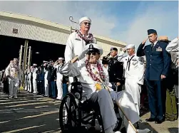  ??  ?? Pearl Harbour survivor Robert Coles salutes active US service members after the ceremonies honouring the 75th anniversar­y of the attack on Pearl Harbour, at Kilo Pier on Joint Base Pearl Harbour - Hickam.