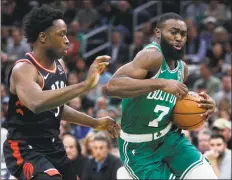  ?? Michael Dwyer / Associated Press ?? The Celtics’ Jaylen Brown (7) drives past the Raptors’ OG Anunoby during the first half on Friday in Boston.
