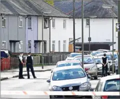  ?? CHRIS J RATCLIFFE/AFP ?? Police stand guard at a cordon during a raid on a home in Sunbury, near London, on Saturday.