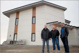  ?? Herald photo by Greg Bobinec ?? Calvin De Jager from Touchstone Homes, Dave Wolf from Greener Homes and Rudy Reger from EnergySmar­t Canada stand in front of the first Net-Negative Home that they designed and built, in the County of Lethbridge.